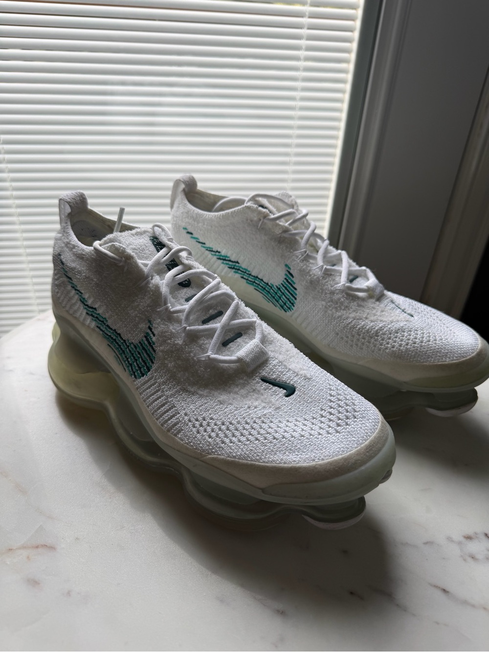 Nike Women’s White Flyknit Sneakers with Teal Swoosh